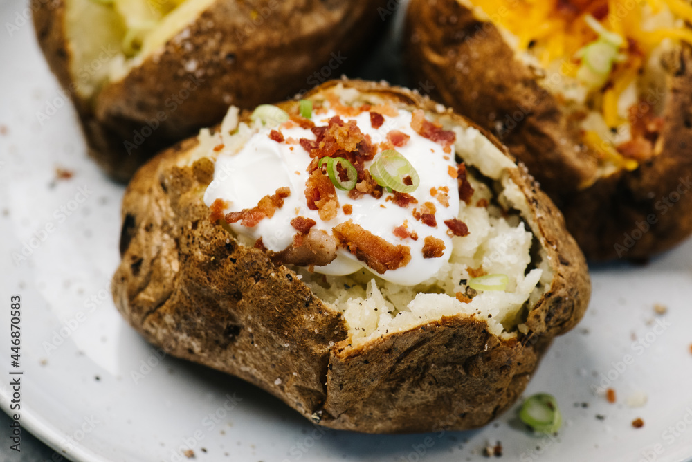 Air fried baked potato with sour cream and bacon