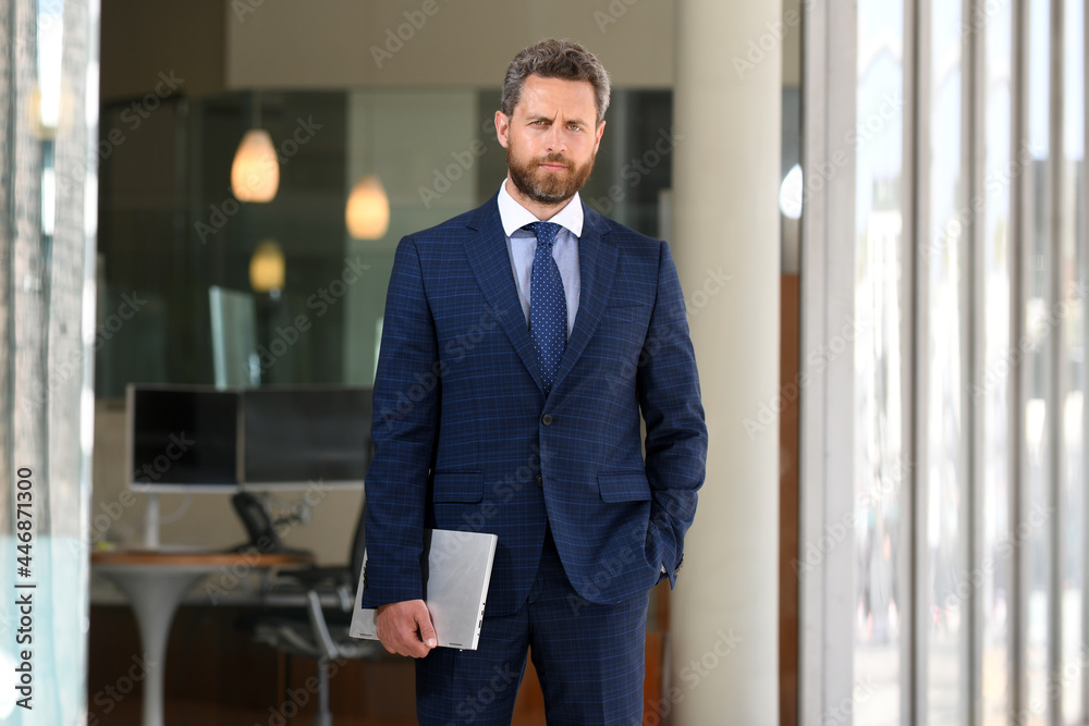 Portrait of businessman standing in a office. Portrait of businessman standing in a office.