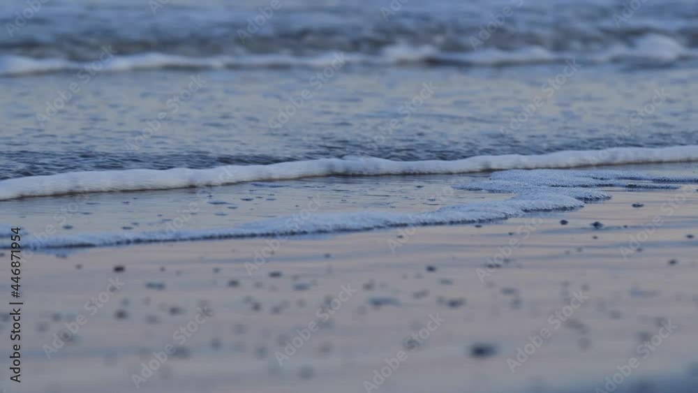 Close up of bubbling tide on Galveston Island beach at dusk low Stock