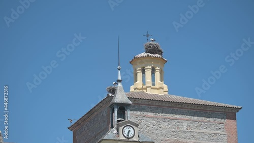 Storks in church steeple in Brunete a sunny spring day photo