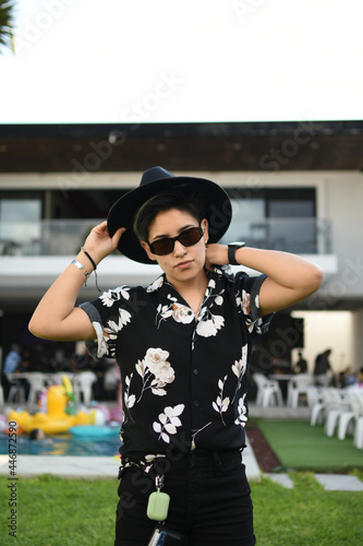 influential Girl with glasses and black outfit posing relax