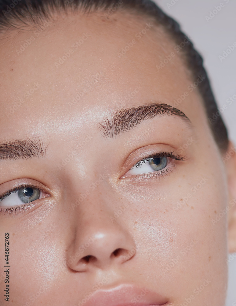 © Cavan Images - Young beautiful woman with clean fresh skin close up - white background