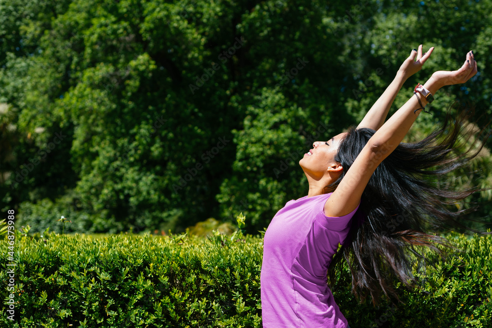 Young cheerful woman dancing outdoor. She is raising her arms on air. Young cheerful woman dancing outdoor. She is raising her arms on air.