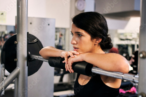 Young woman resting after a workout in a gym