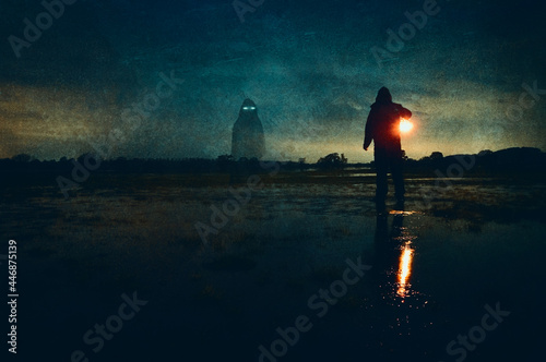 A haunted concept. Of a man with a lamp looking at a spooky ghost with glowing eyes. On flooded fields on a winters night