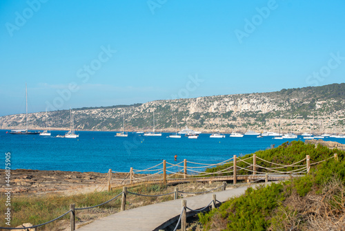 Beautiful view of Formentera, Spain with yacts near the Es Calo beach in in the summer photo