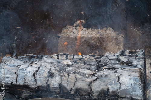 Smoldering firewood close up. burning wood log in the fireplace