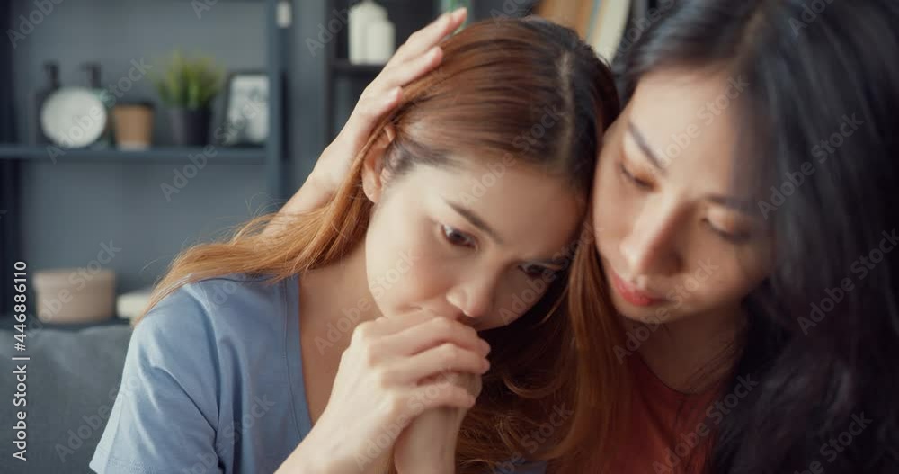 Asian women teenager embracing to calm her sad best friends from feeling down from breakup with boyfriend in living room at home. Friendship counseling and care, unhappy girl support her girlfriend. Asian women teenager embracing to calm her sad best friends from feeling down from breakup with boyfriend in living room at home. Friendship counseling and care, unhappy girl support her girlfriend.