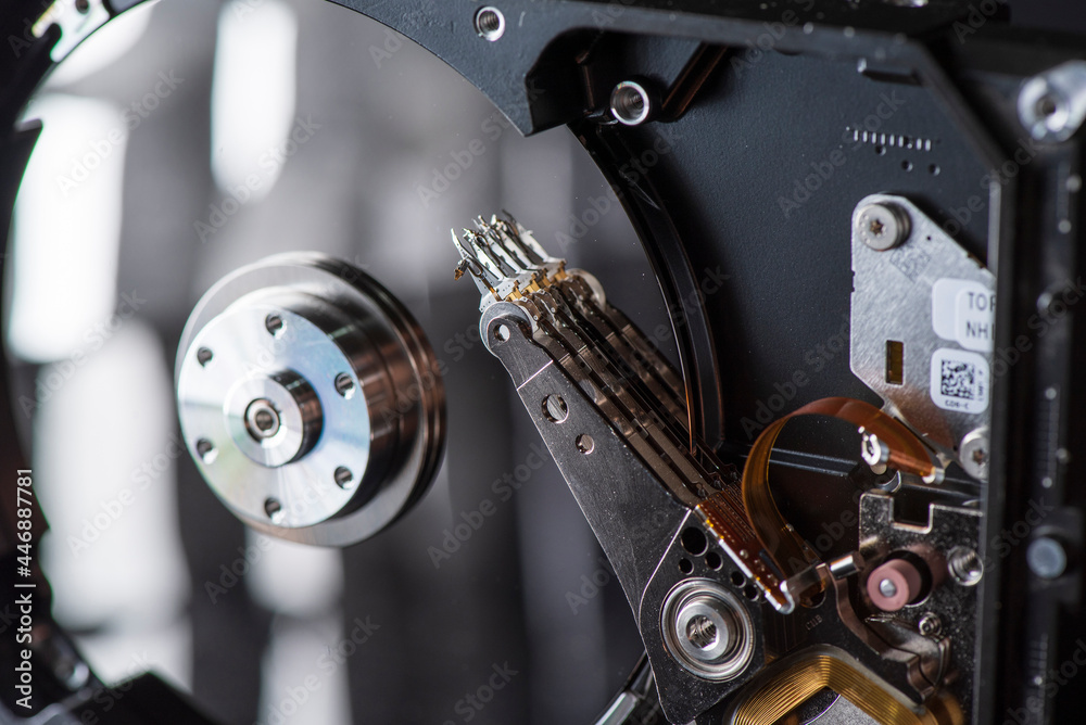 Fragment of a disassembled hard drive, against a dark background. Fragment of a disassembled hard drive, against a dark background.