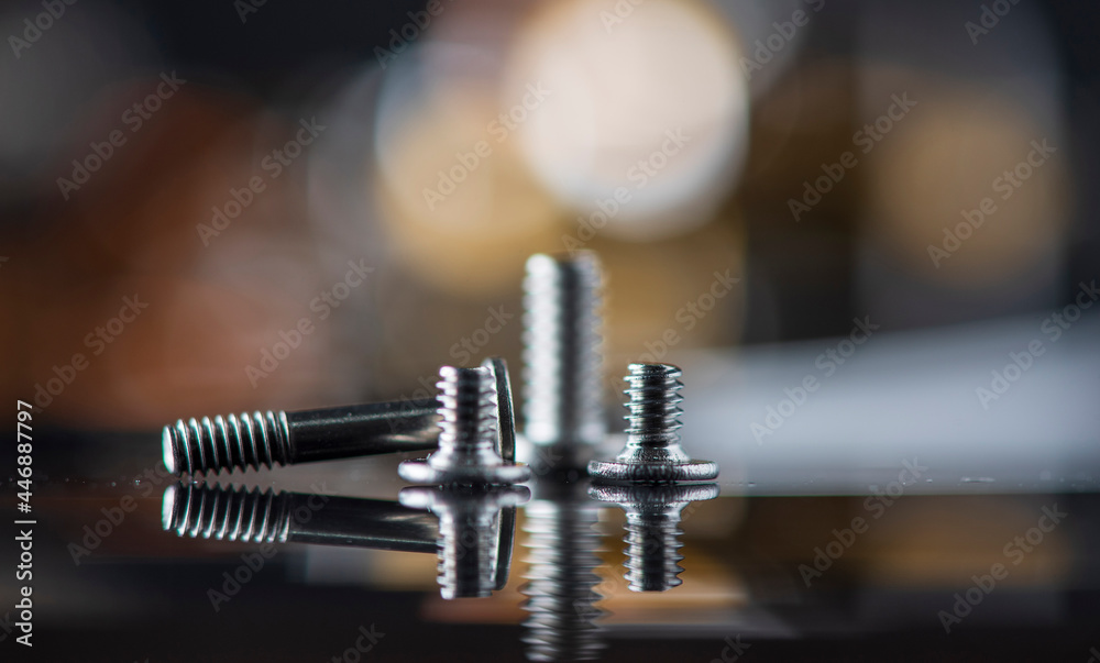 Fragment of a disassembled hard drive, against a dark background. Fragment of a disassembled hard drive, against a dark background.