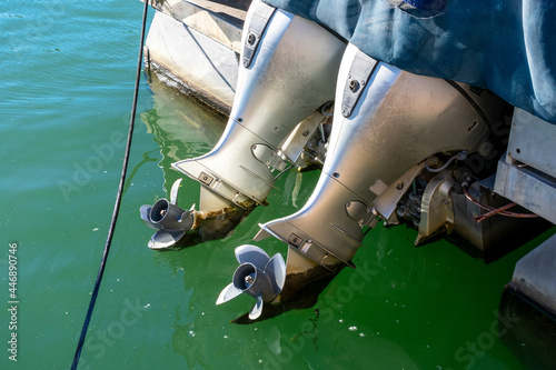 Two powerful outboard engines on the boat. Propeller from outboard motor out of the water. photo