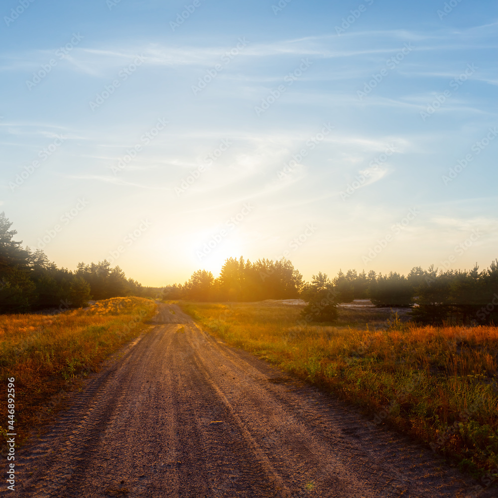 ground road among prairie at the sunset