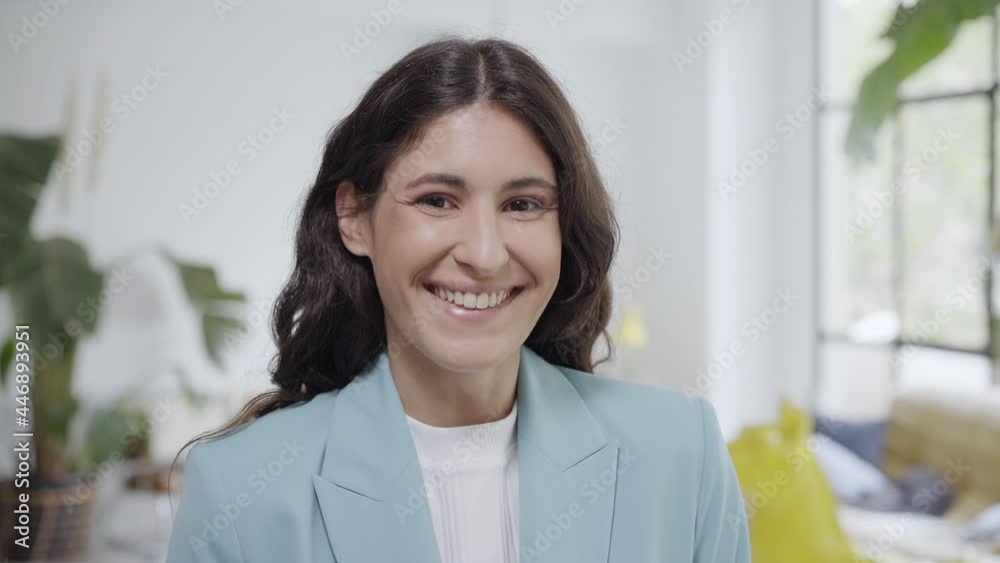 Slow motion of a young business woman looking at the camera and smiling. Portrait of a happy latina woman's face looking at camera with a smile. Slow motion of a young business woman looking at the camera and smiling. Portrait of a happy latina woman's face looking at camera with a smile.