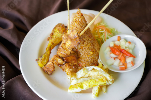 Chicken satay fried rice on white plate. photo