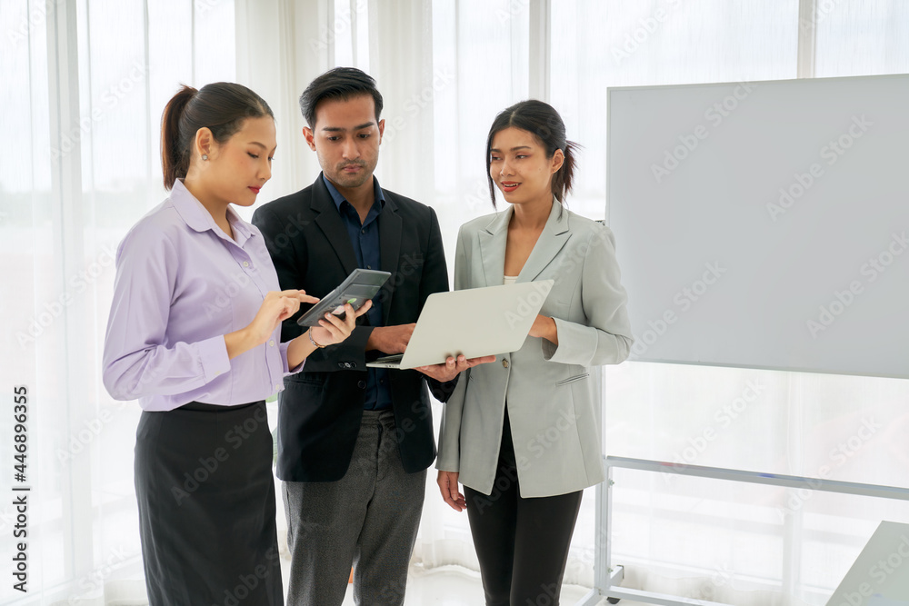 Businesspeople team discussion with laptop and calculator by leadership and team in business seminar room Businesspeople team discussion with laptop and calculator by leadership and team in business seminar room