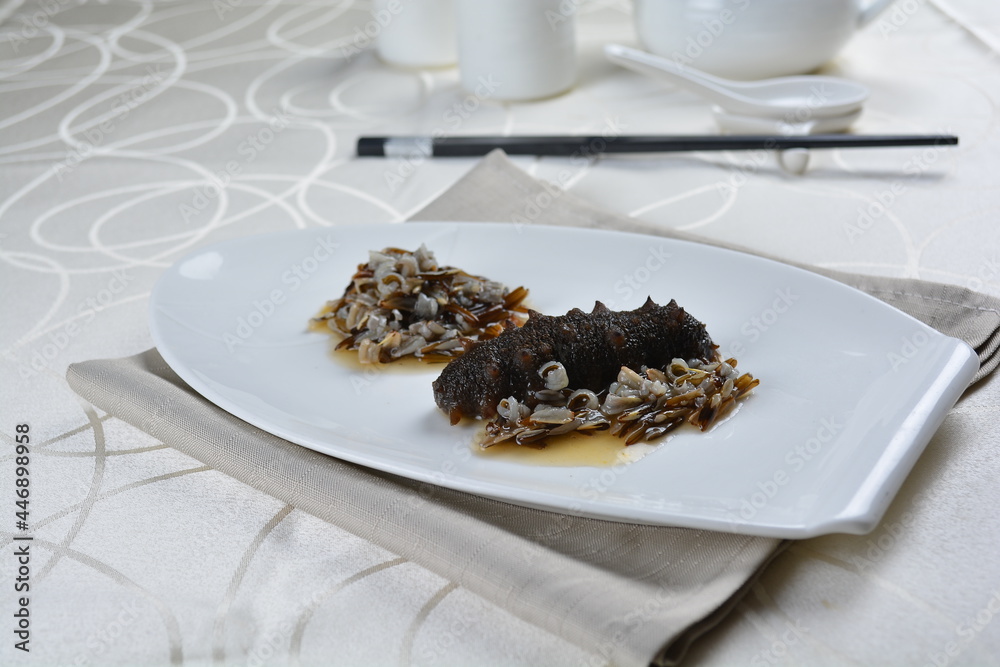 braised cook whole sea cucumber with vegetable in special chef oyster thick sauce in white background asian halal seafood menu braised cook whole sea cucumber with vegetable in special chef oyster thick sauce in white background asian halal seafood menu