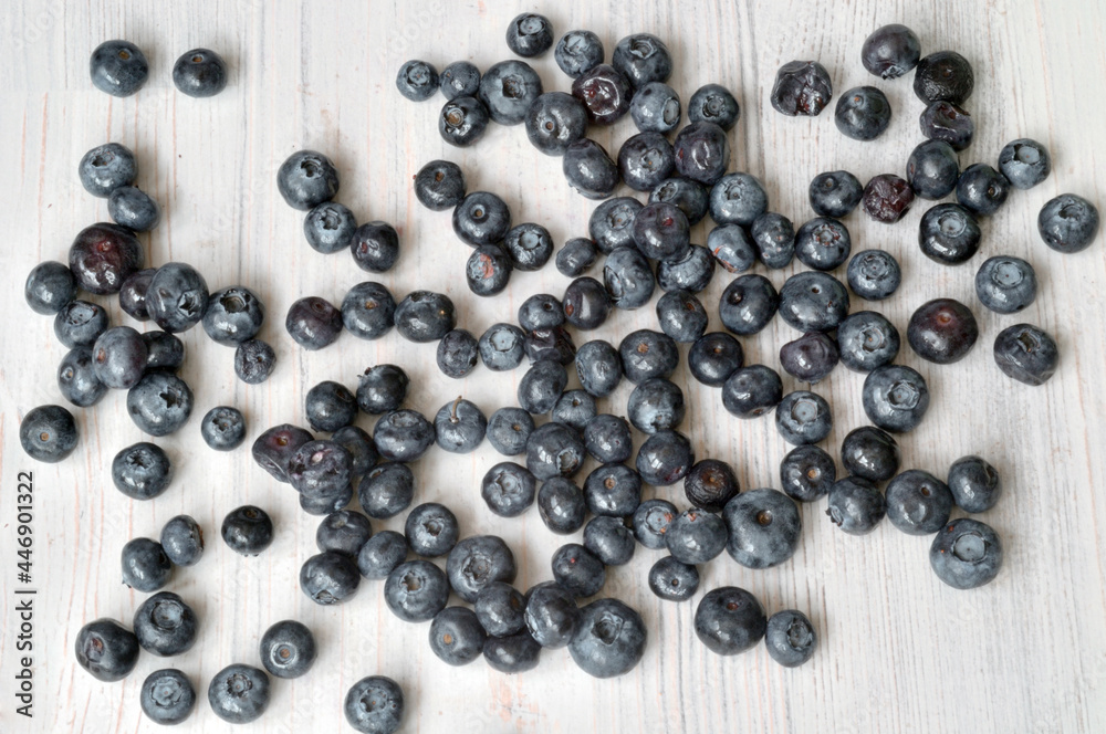 blueberry berry scattered on a light table blueberry berry scattered on a light table