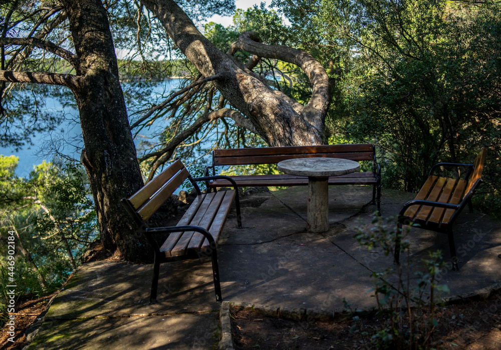 concrete table and chairs in an old park on the island of Rab, Croatia concrete table and chairs in an old park on the island of Rab, Croatia