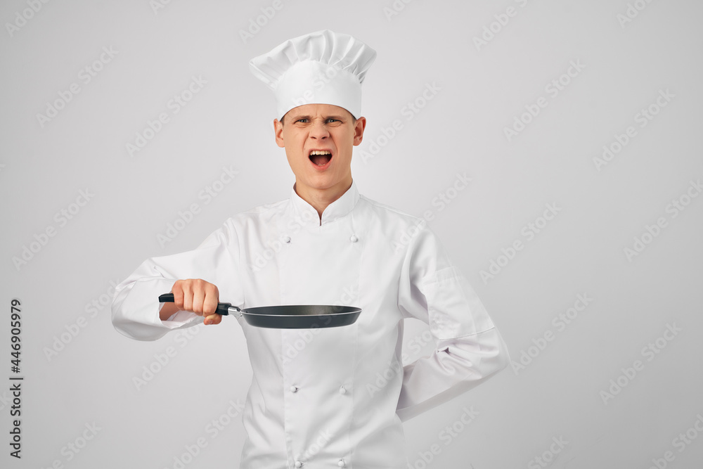 man in chef's clothes Frying pan in hands cooking professionals work man in chef's clothes Frying pan in hands cooking professionals work