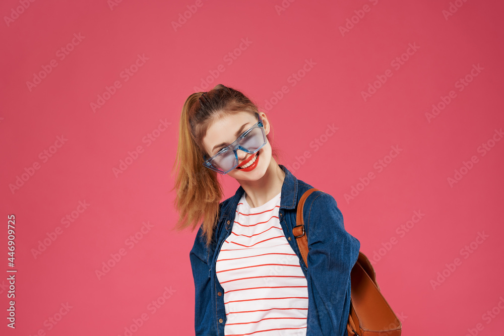 cheerful woman with a backpack holding her hair teen backpack student cheerful woman with a backpack holding her hair teen backpack student