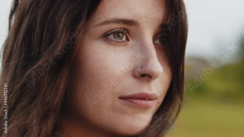 Young beautiful woman opening her ashy green eyes photo