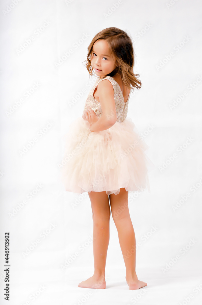 Portrait of happy pretty curly little girl standing and posing over white background Portrait of happy pretty curly little girl standing and posing over white background