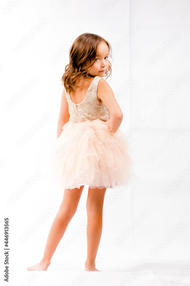 Portrait of happy pretty curly little girl standing and posing over white background Portrait of happy pretty curly little girl standing and posing over white background