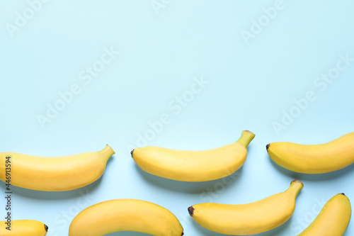 Sweet ripe baby bananas on turquoise background, flat lay. Space for text