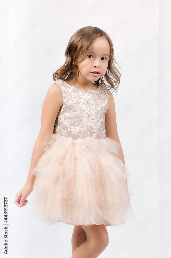 Portrait of happy pretty curly little girl standing and posing over white background Portrait of happy pretty curly little girl standing and posing over white background