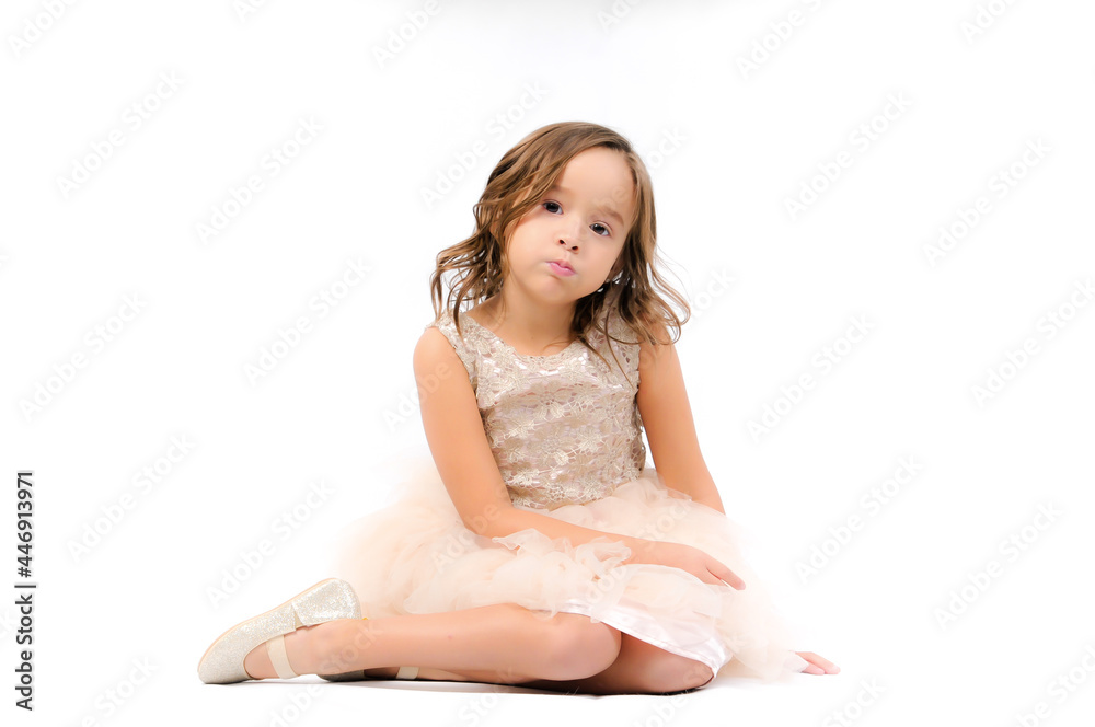 Portrait of happy pretty curly little girl relaxing, sitting and posing over white background Portrait of happy pretty curly little girl relaxing, sitting and posing over white background
