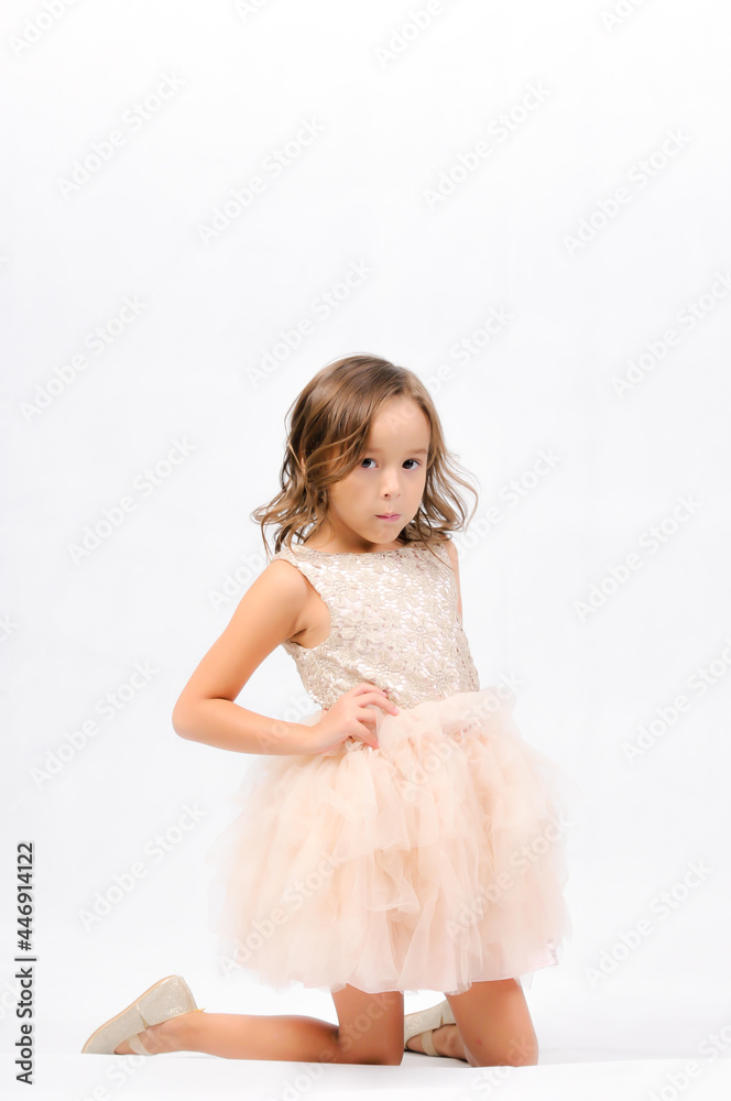 Portrait of happy pretty curly little girl standing and posing over white background Portrait of happy pretty curly little girl standing and posing over white background