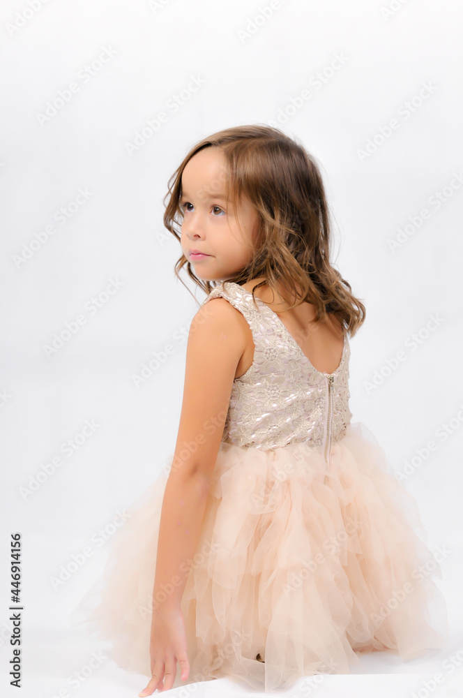 Portrait of happy pretty curly little girl standing and posing over white background Portrait of happy pretty curly little girl standing and posing over white background