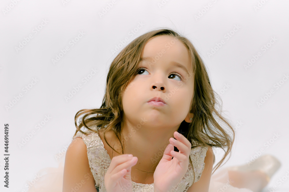 Portrait of happy pretty curly little girl standing and posing over white background Portrait of happy pretty curly little girl standing and posing over white background
