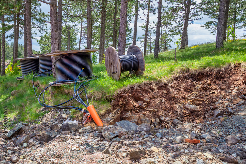 Fototapeta premium High voltage electrical cable and water pipes is laid in a trench full of stones