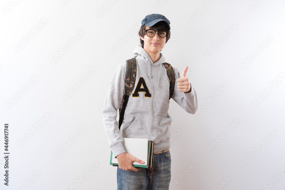 Handsome teen student with school bag and books on white background. Handsome teen student with school bag and books on white background.
