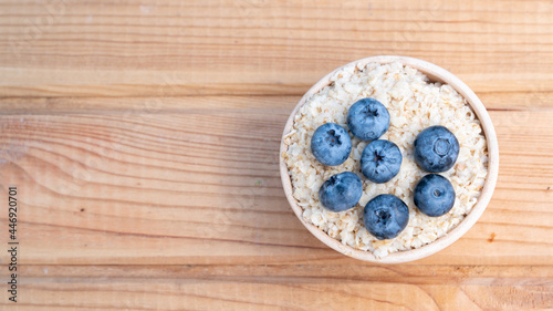 Breakfast cereals in bowl served with and blueberries. Clean eating, healthy food diet concept