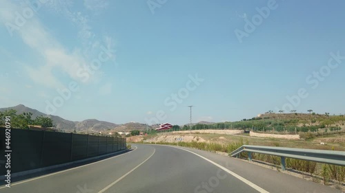 The view from the window of a car that rides on a beautiful European road.