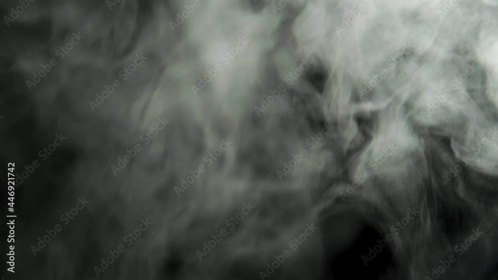 Clouds of dense smoke on a black background. The smoke moves and fills the space. Abstract background. Clouds of dense smoke on a black background. The smoke moves and fills the space. Abstract background.