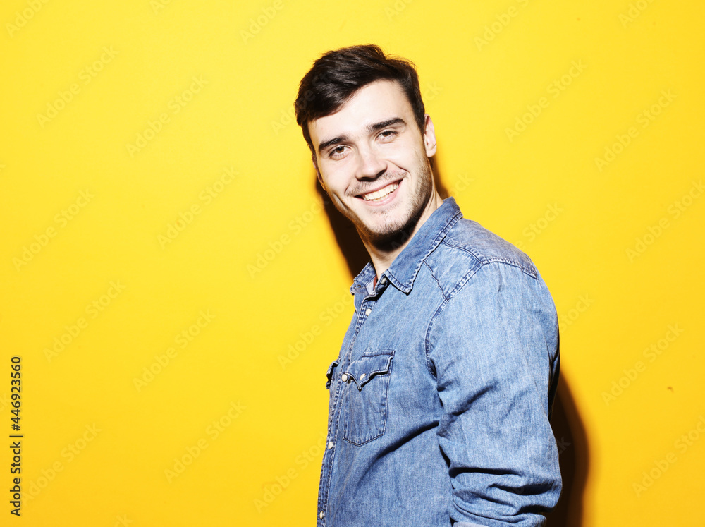 Portrait of a handsome man smiling against yellow background. Portrait of a handsome man smiling against yellow background.