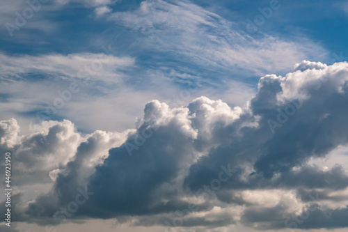 Blue sky background with big white tiny stratus cirrus striped clouds