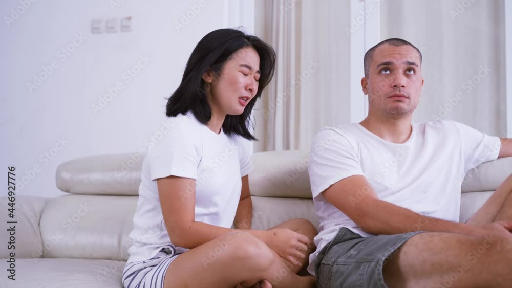 Sad woman scolding her husband at home Sad woman scolding her husband at home