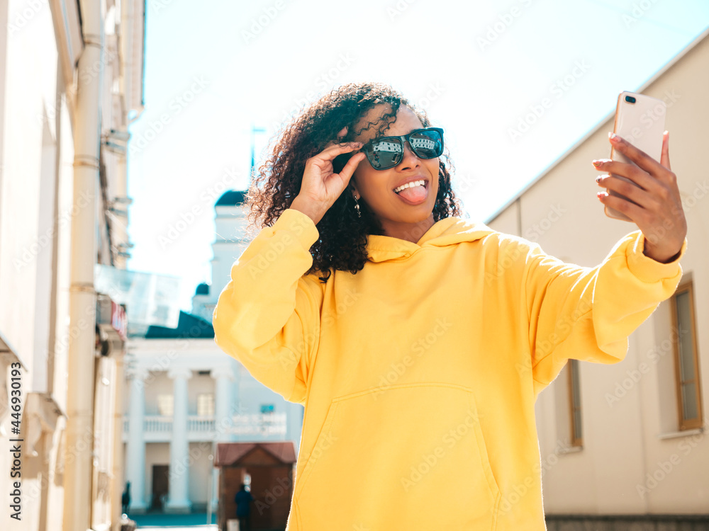 Smiling Woman in Yellow Hoodie with Creative Makeup  Free Stock Photo