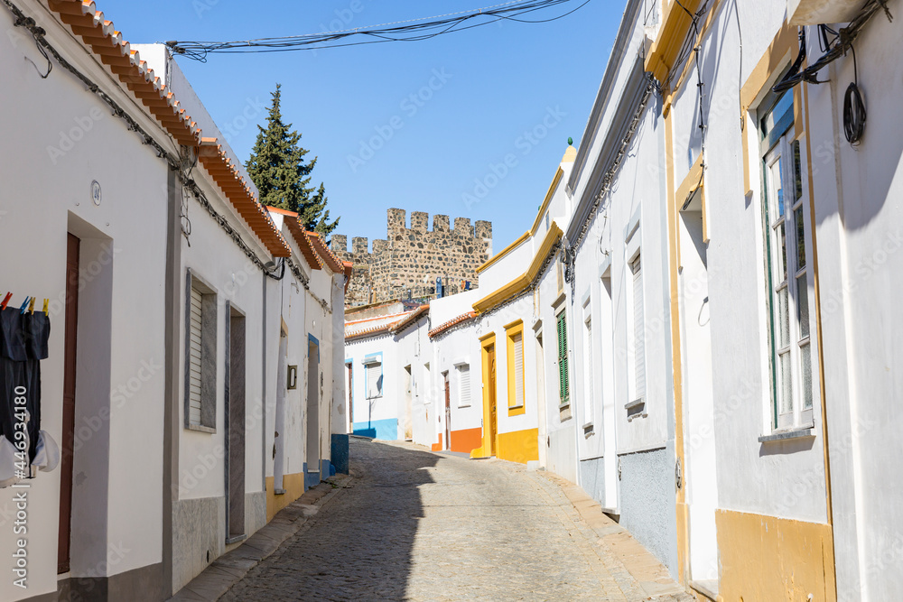 Fototapeta premium a cobbled street with typical white houses in Beja city, Alentejo, Portugal