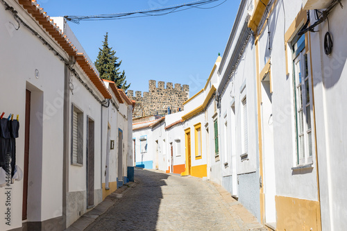 a cobbled street with typical white houses in Beja city, Alentejo, Portugal 