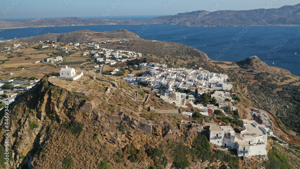 Aerial drone photo from uphill Venetian castle and small chapel overlooking the Aegean sea on top of scenic cliff in chora, capital of Milos island, Cyclades, Greece