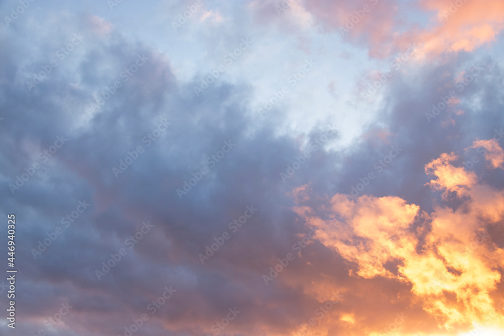 Colorful sky background: dreamy and moody blue, purple and yellow cloudy sunset or sunrise