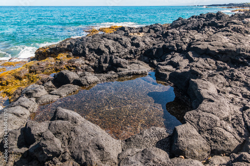 Tide Pools and Ancient Lava Flow on The Shore of Puialoa Point, Kekaha Kai State Park, Hawaii Island, Hawaii, USA photo