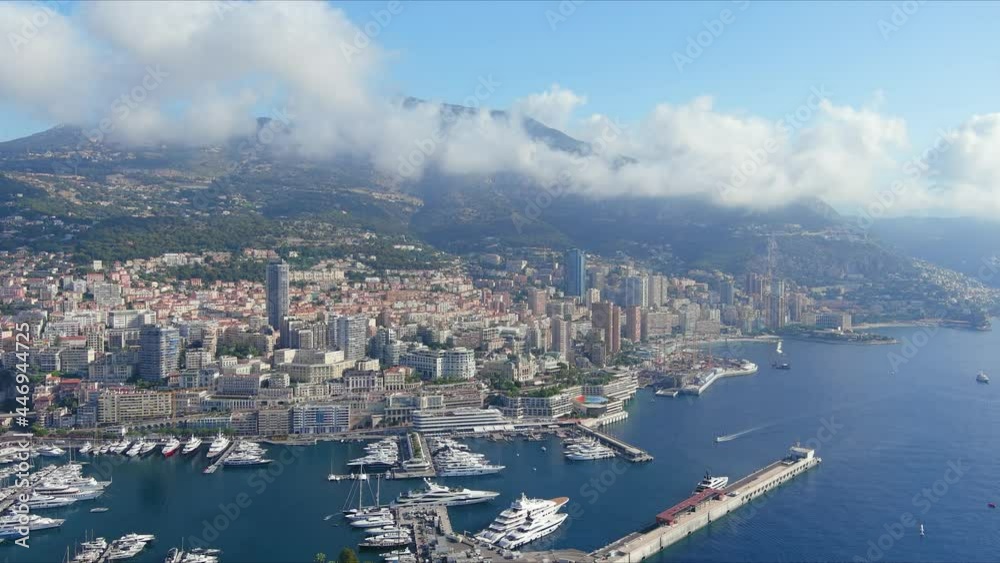Monte Carlo, Monaco. Aerial view of famous city towering over Mediterranean Sea, yachts and boats in marina Port Hercules in La Condamine - landscape panorama of Europe from above Monte Carlo, Monaco. Aerial view of famous city towering over Mediterranean Sea, yachts and boats in marina Port Hercules in La Condamine - landscape panorama of Europe from above