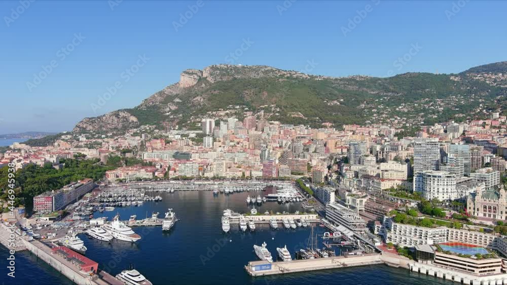 Monte Carlo, Monaco. Aerial view of famous city towering over Mediterranean Sea, yachts and boats in marina Port Hercules in La Condamine - landscape panorama of Europe from above