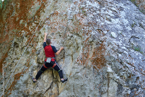 Top rope climbing. Extreme outdoor sports. Climbing in the summer, training for beginners. Easy climbing track.